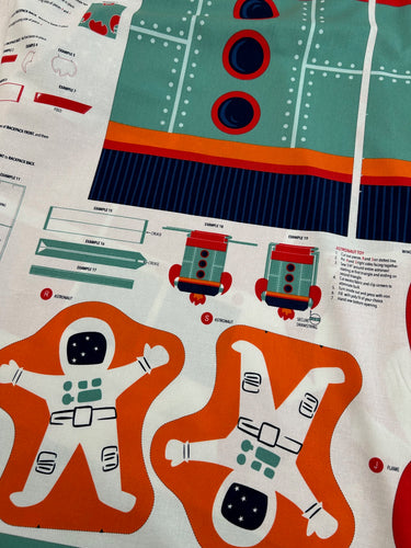 blast off 321 stacy iest hsu for moda fabric shack malmesbury rocket back pack with astronaut doll panel 1